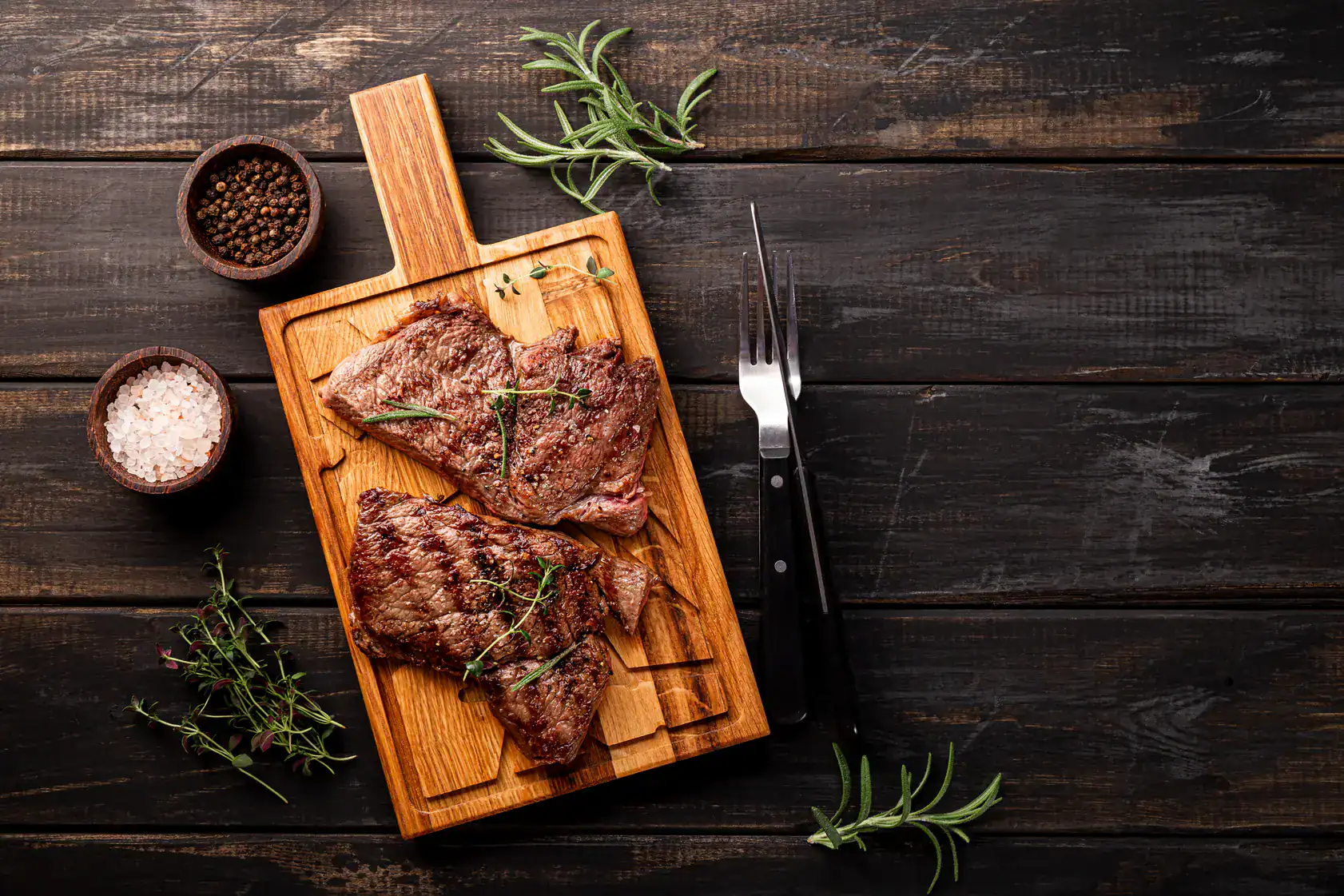 Delicious steak topped with herbs and complemented by truffle, ready to enjoy.